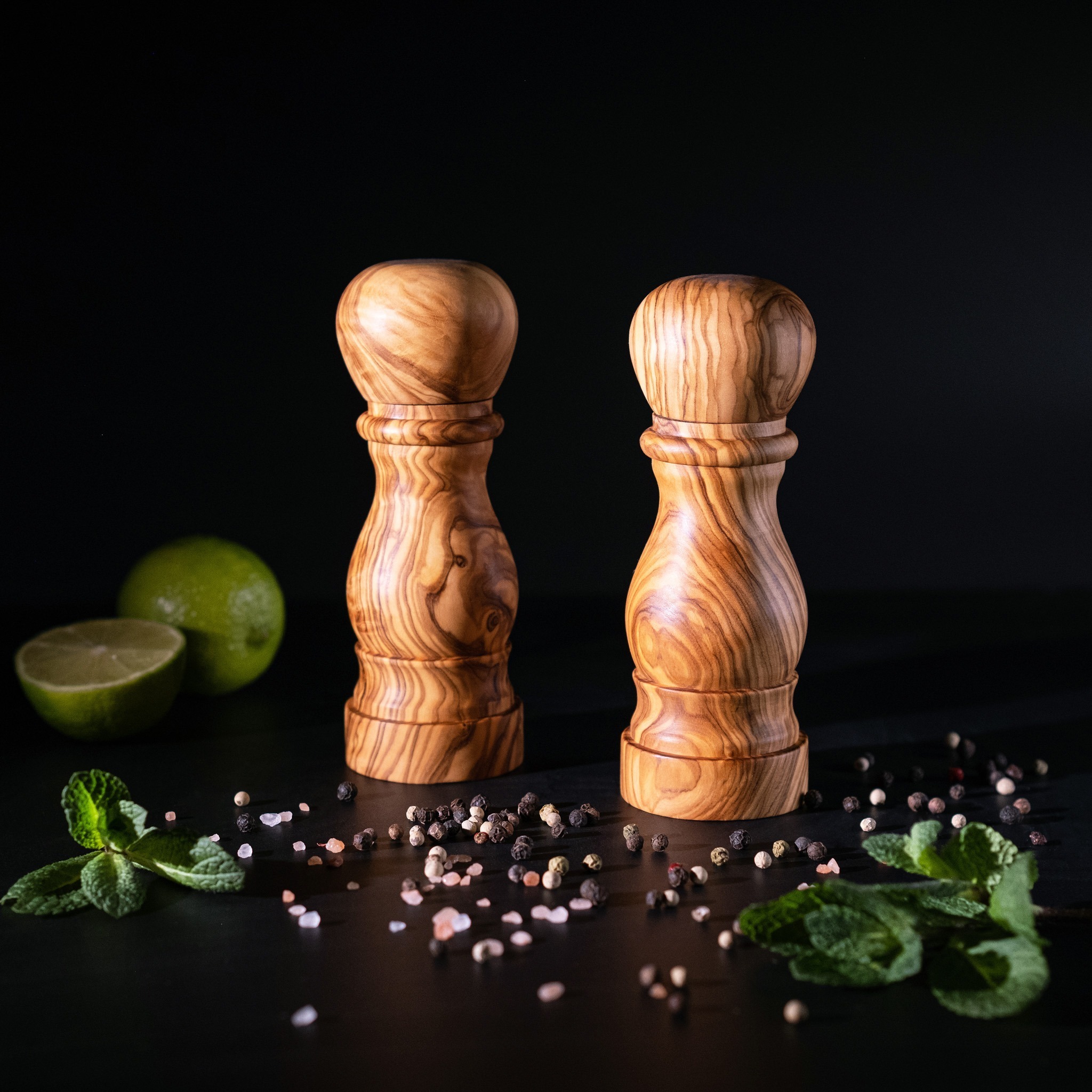 A salt and pepper shakers with pepper and spices.