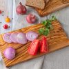 A Rectangular Olive Wood Cutting Board with tomatoes, onions and bread.