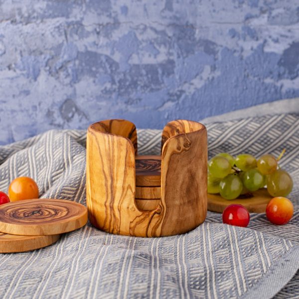 A wooden coaster set with fruit and grapes.