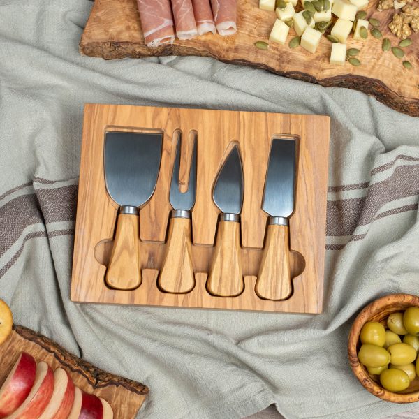 A wooden cheese board with cheese, olives and olives.