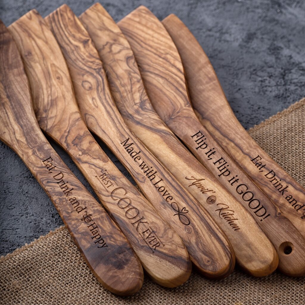 Five engraved olive wood spatulas.