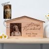 A wooden house with a photo of a woman and flowers.