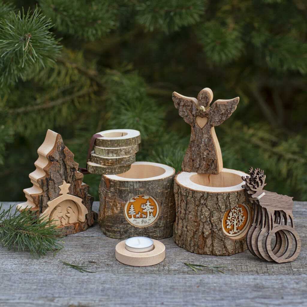 A set of wooden christmas ornaments on a wooden table.
