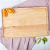 A wooden cutting board with orange slices on it.
