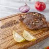 A Recipe Steak Cutting Board with a steak on it.