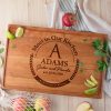A wooden cutting board with the words'meet in our kitchen adams'.