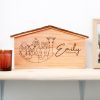 A wooden nativity scene with the name elly on it.