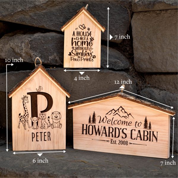 Three wooden signs with the name howard's cabin.
