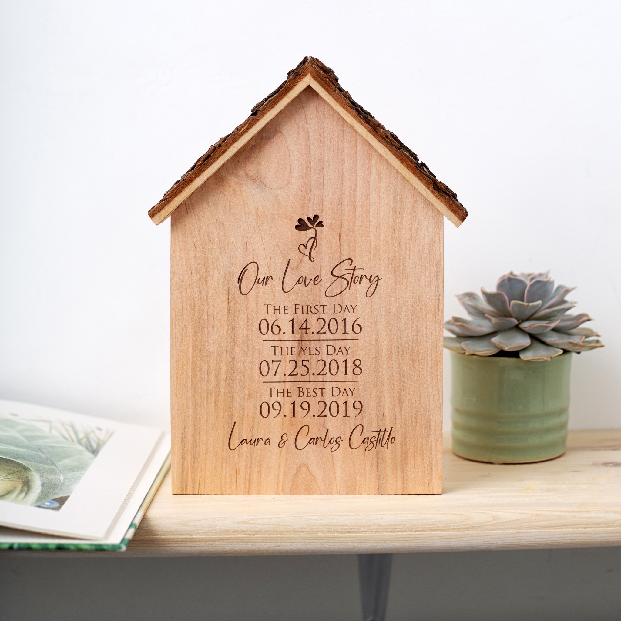 A wooden house with a clock on it and a plant on it.