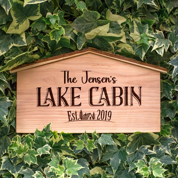 A wooden sign that says the jennifer's lake cabin.