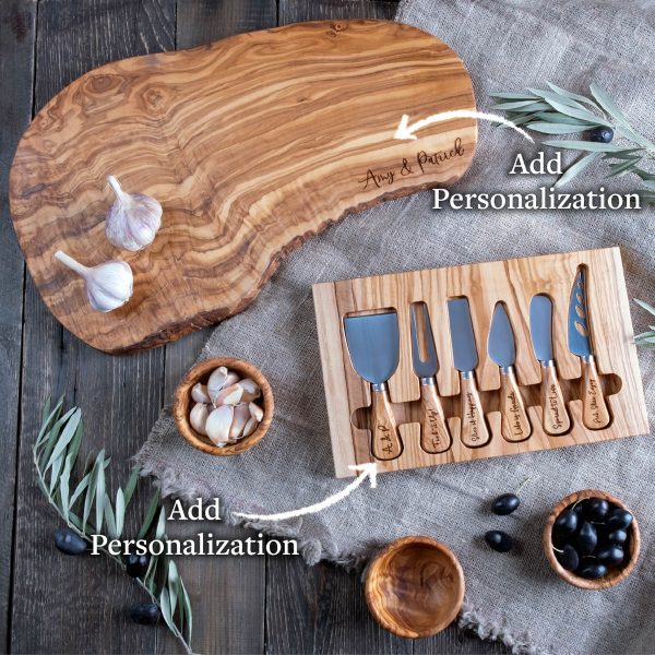 Personalized cheese board with olives and olive oil.