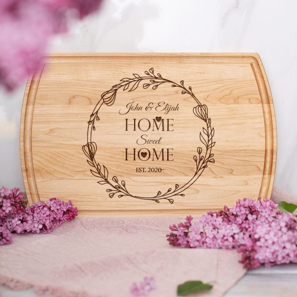 A cutting board with the words home sweet home on it.