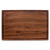 A meat cutting boards juice grooves on a white background.