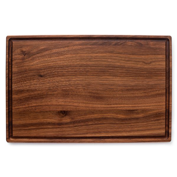 A meat cutting boards juice grooves on a white background.