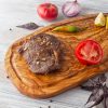 An Olive Wood Board with Juice Groove with a steak on it.