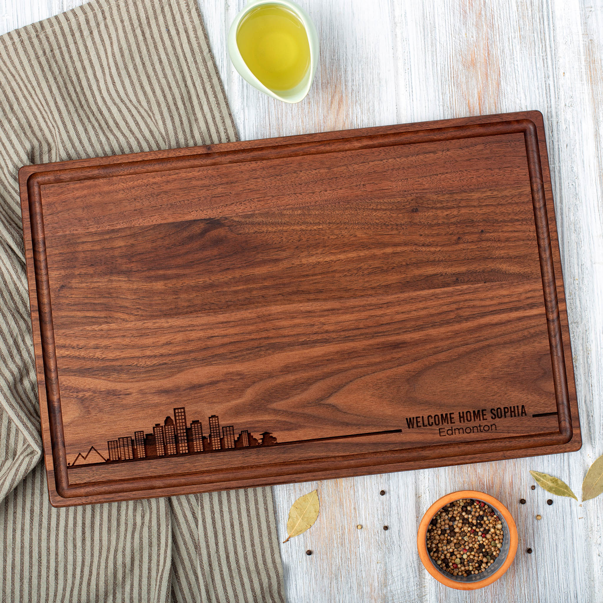 A walnut cutting board with a city skyline on it.