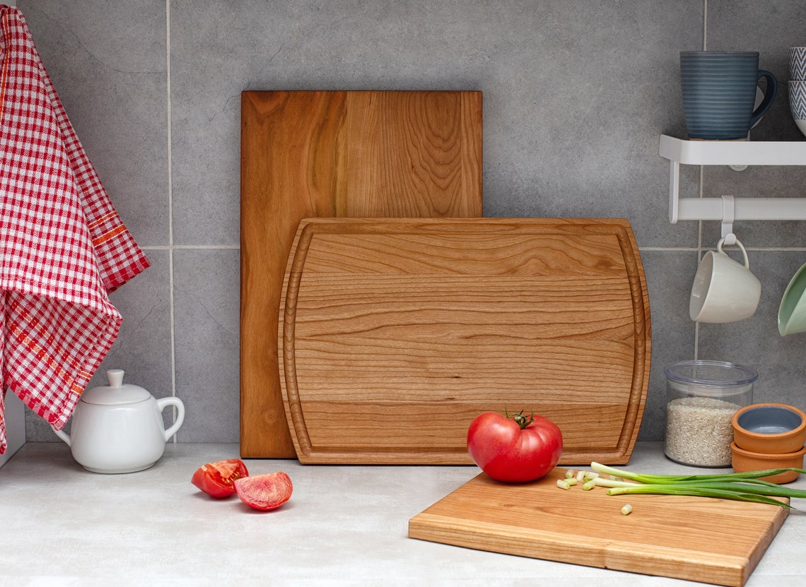 three wooden cutting board on a kitchen counter.