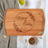 A wooden cutting board with the words richard and adelaide on it.