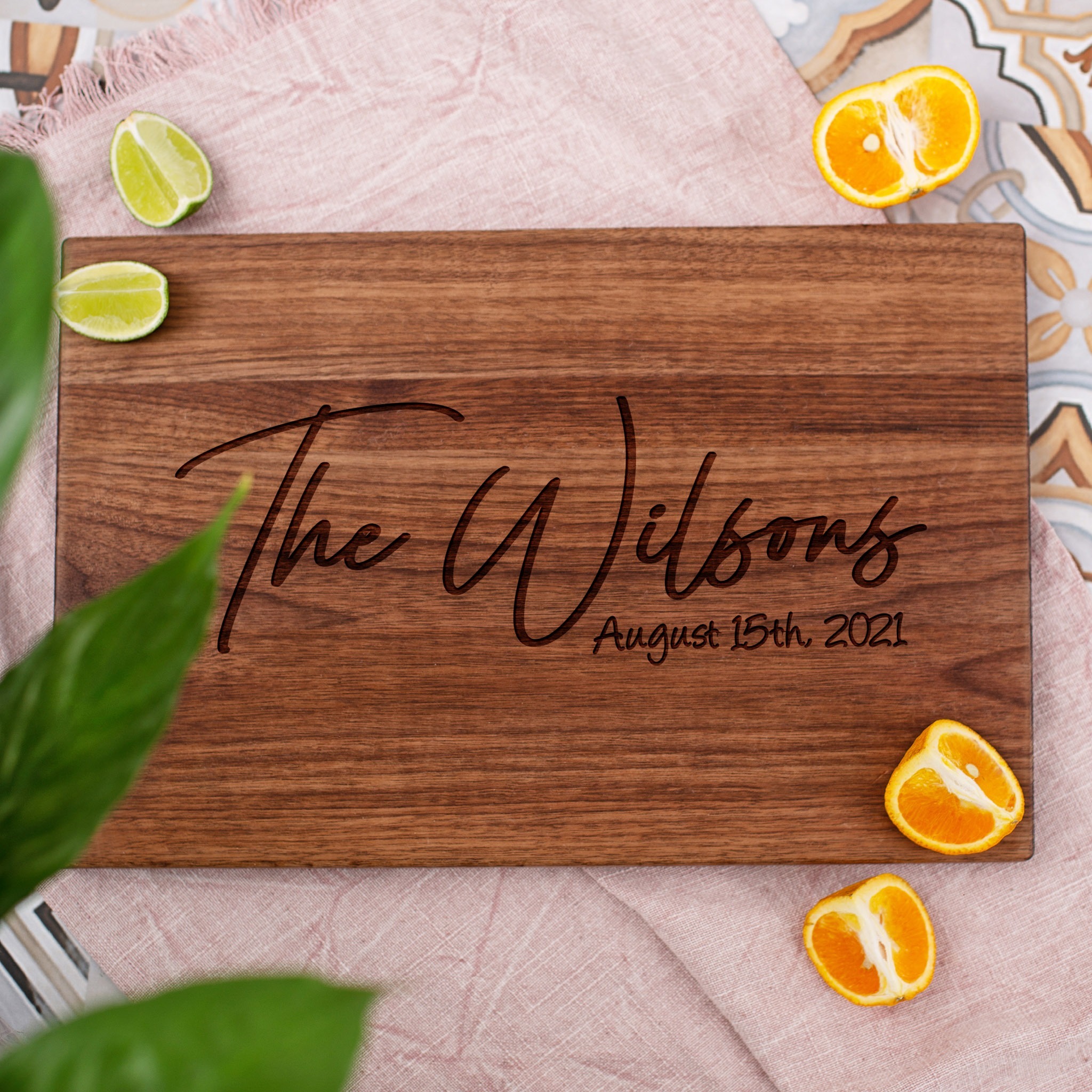 A wooden cutting board with the name the wilson's on it.