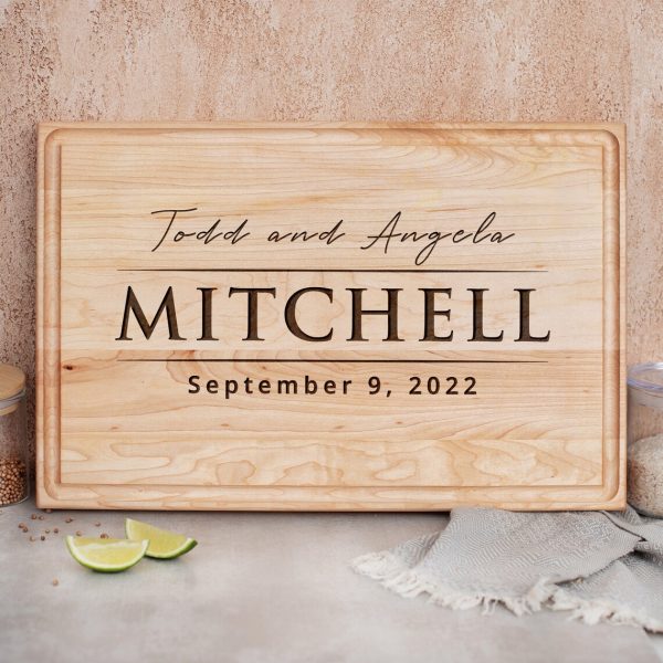 A wooden cutting board with the word mitchell on it.
