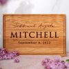 A wooden cutting board with the words'todd and mitchell'.