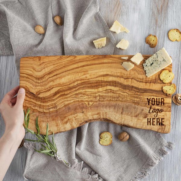 A person holding a custom logo cutting board.
