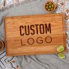 A wooden cherry cutting board with the word custom logo on it.
