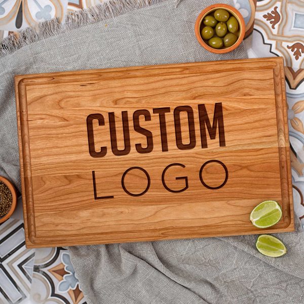 A wooden cherry cutting board with the word custom logo on it.