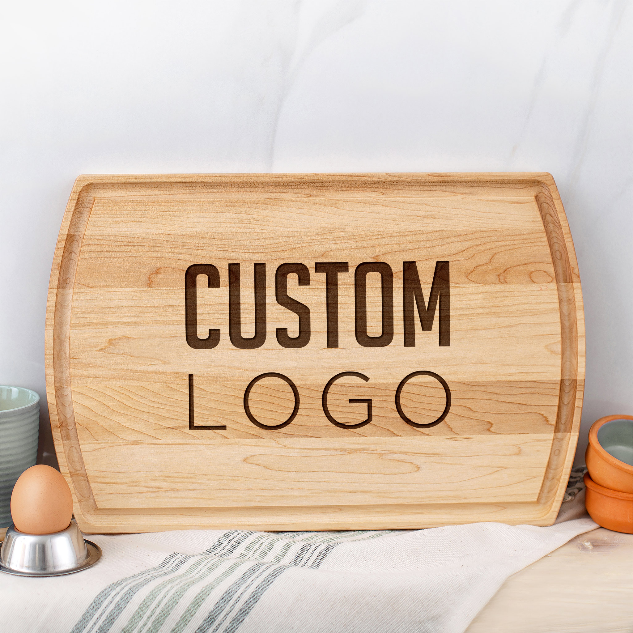 A custom maple cutting board with engraved logo.