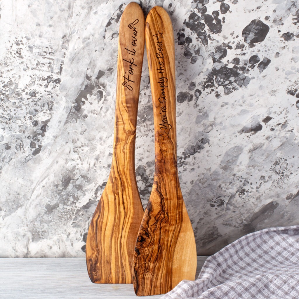 Two wooden spatulas with names on them.